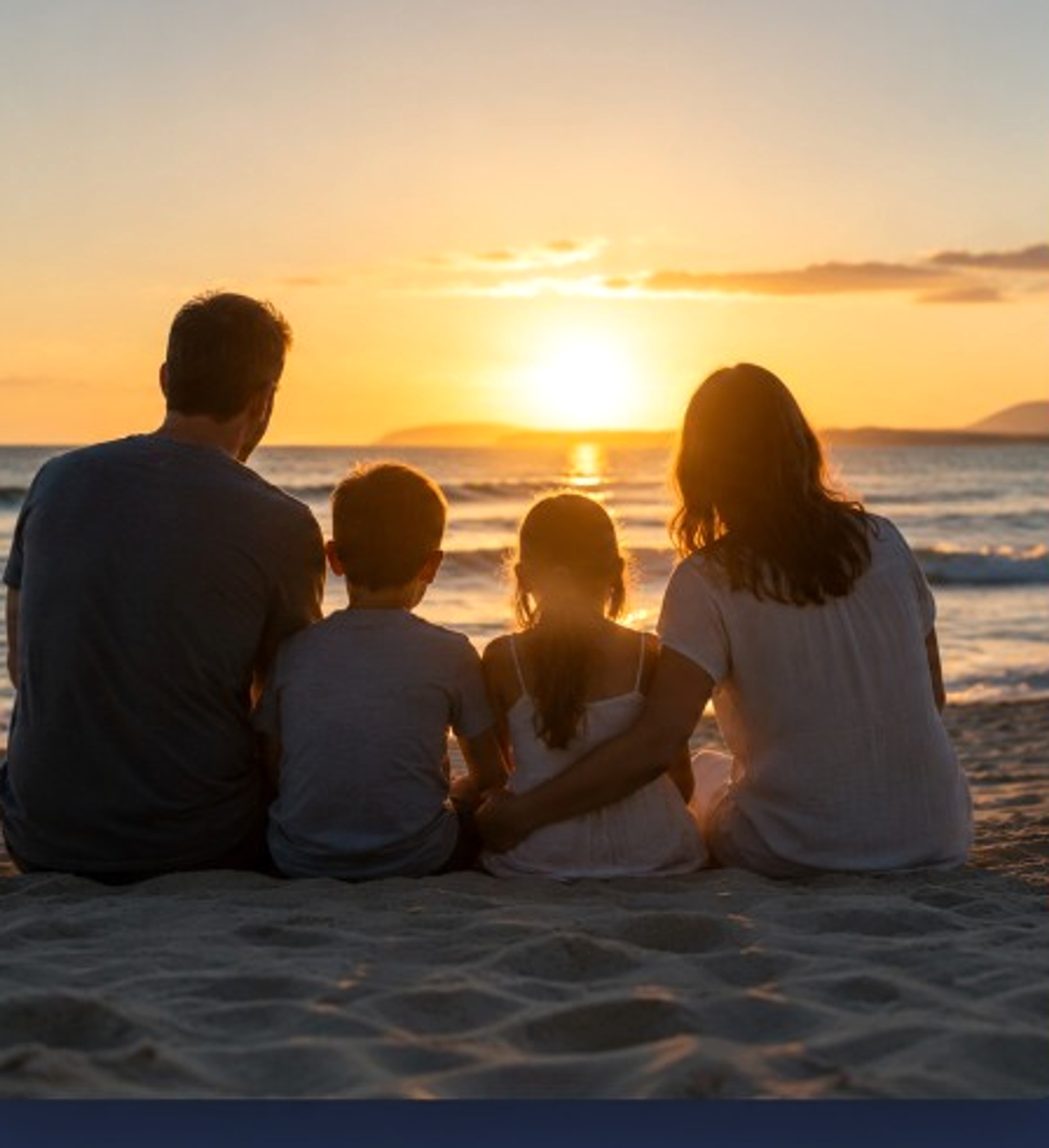 A family sitting together on the beach at sunset, protecting what matters most